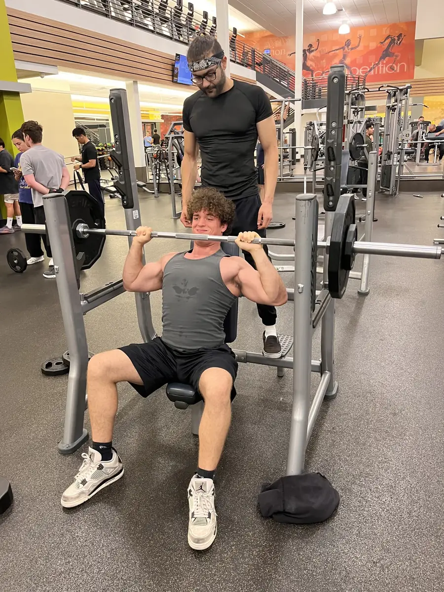 Haiko coaching a client through a shoulder press in a Los Angeles gym
